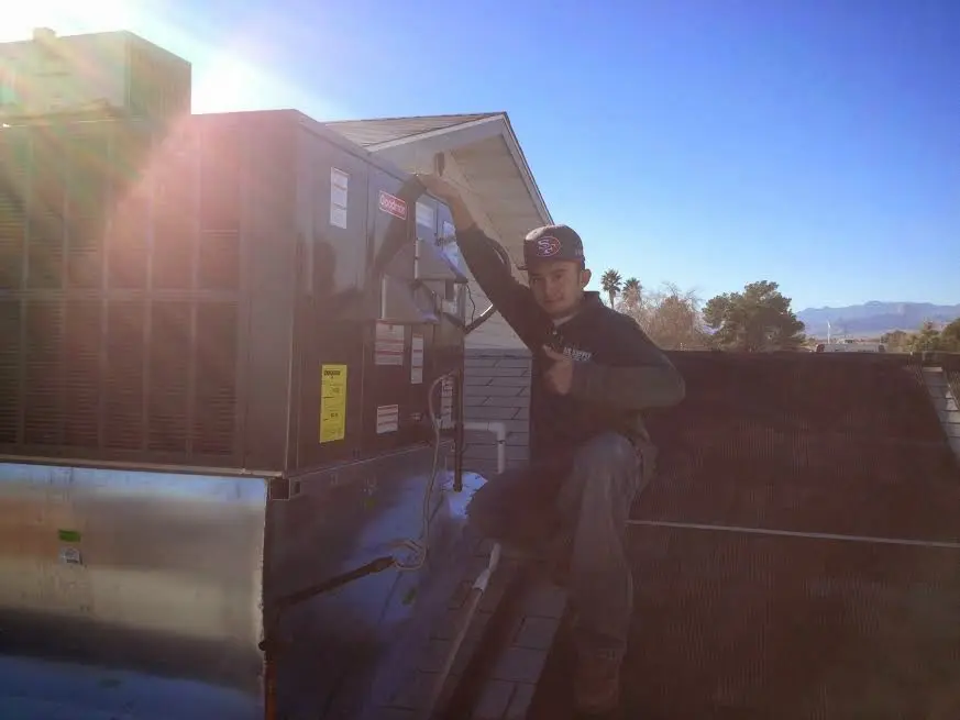 HVAC technician performing HVAC Inspection on a rooftop unit in Goffstown